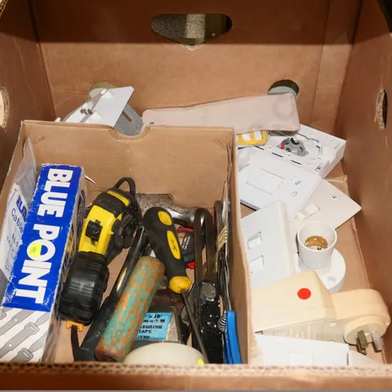 box of electrical switches, tape measures, hammer, etc.