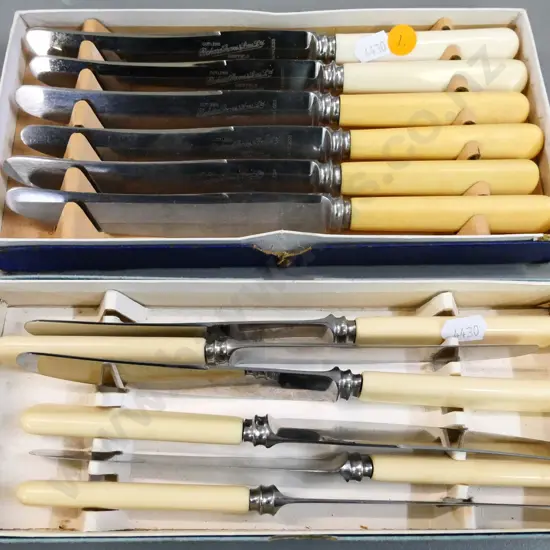 2 boxed sets of bone-handled dinner knives - one set has 4 discoloured handles