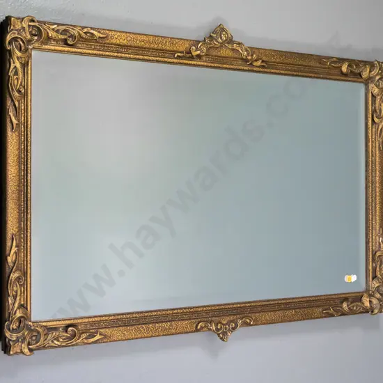 ornate gilt-framed bevelled wall mirror - minor cracks and damage to frame trim H-600 W-900