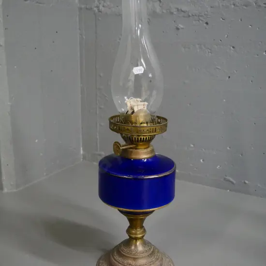 metal and porcelain kerosene lamp with chimney. Some wear to gilt decoration, pitting to metal H-330 w/out chimney