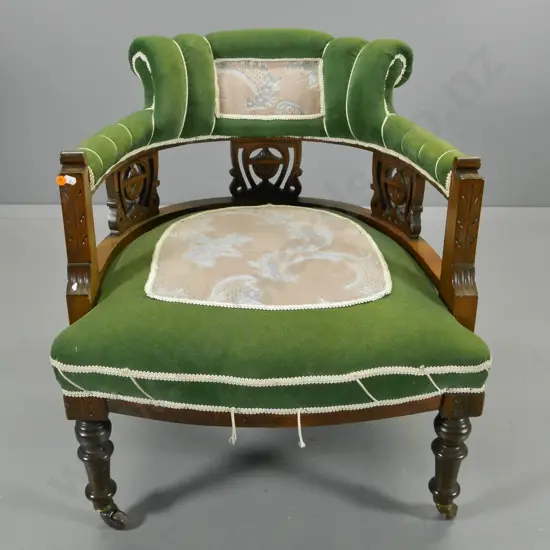 Edwardian tub chair with carved & fretted panels, on casters, some fading to velvet, loose trim H700 W620 D600