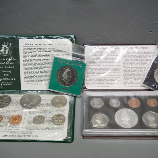 Cased New Zealand coin sets - 1980 souvenir set with dollar, 1981 proof set, and 2 individual dollars