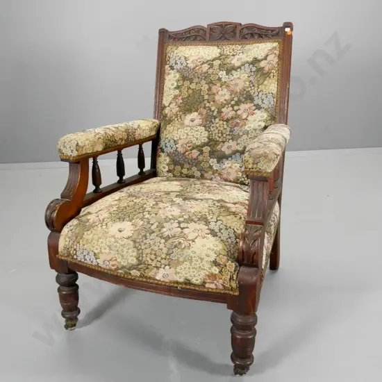 Edwardian armchair w/carved top rail, spindle sides, porcelain casters, some fading to tapestry H940 W640 D700