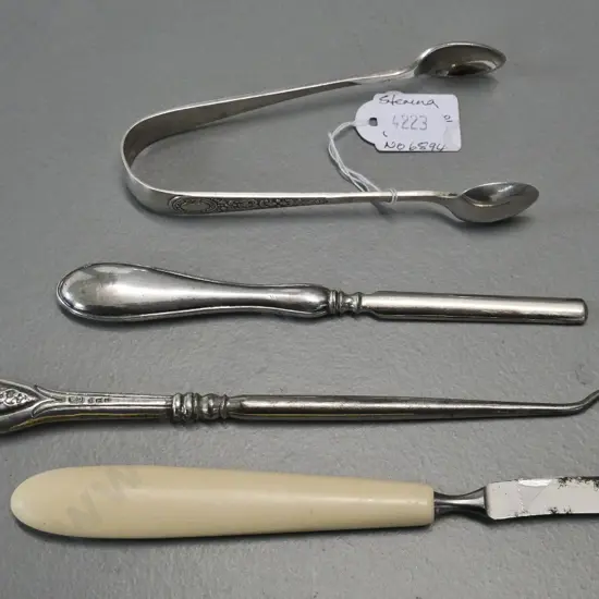 3 pieces sterling silver - button hook, nail implement and sugar tongs - and a bone handled manicure item