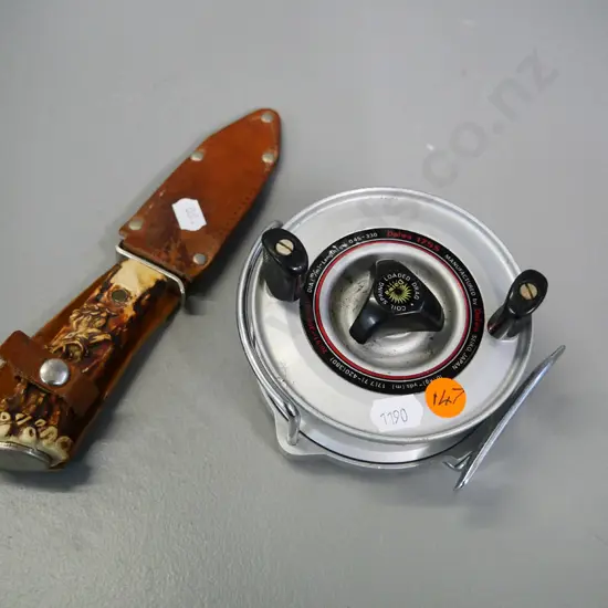 Daiwa 175s fishing reel and a German knife in leather sheath