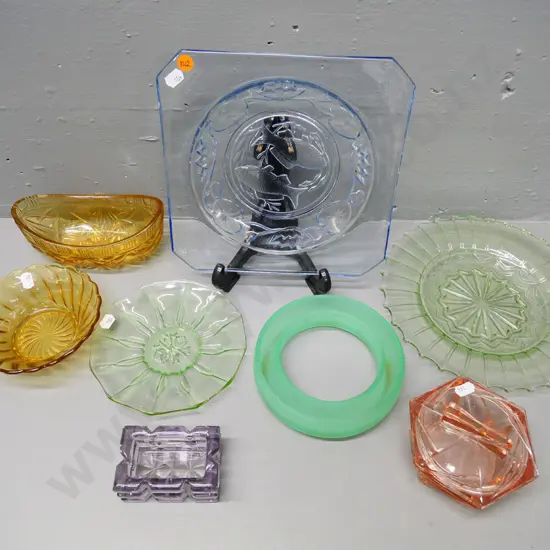 collection of coloured depression glass items including blue fish dish, green plates, pink jewellery box etc.