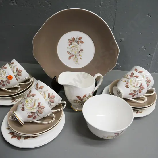 Queen Anne 21-piece brown and cream rose pattern tea set - scratches to plate, crack thru one cup