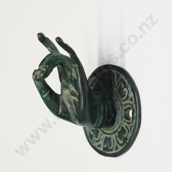 small brass ring holder in the shape of a hand
