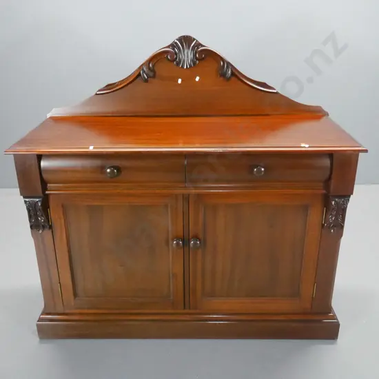 reproduction mahogany chiffonier w/carved back and corbels, 2 doors, 2 drawers - back a bit loose. H1160 W1200 D480