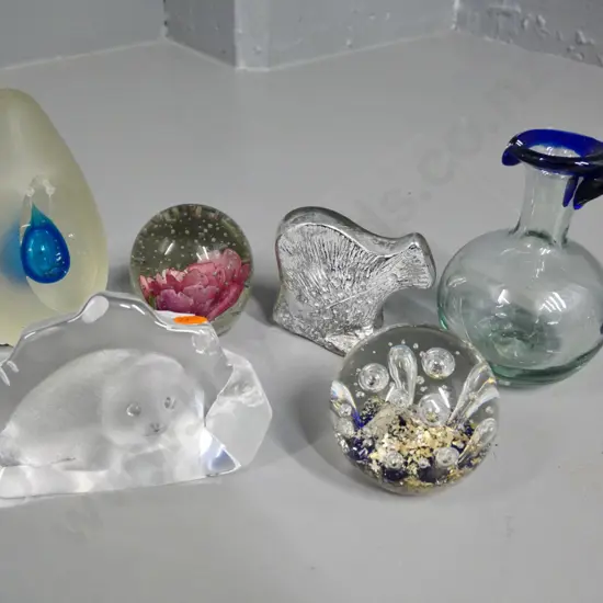 6 glass items - 4 paperweights, seal in relief and a small jug H-130
