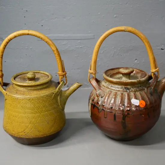 2 studio pottery teapots with cane handles - taller is H-280
