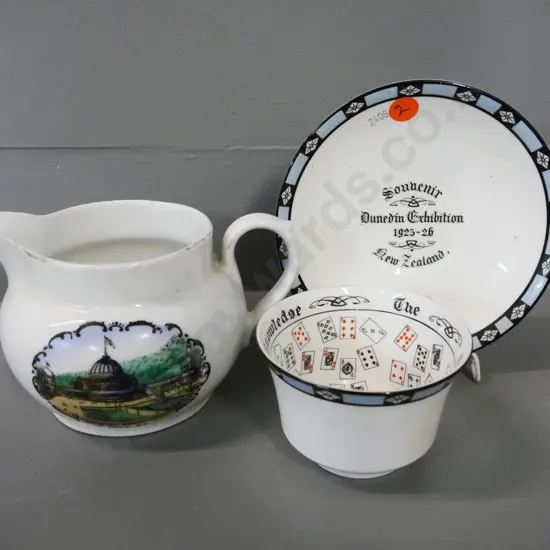 2 pieces of 1925-26 Dunedin Exhibition ware - fortune teller cup & saucer and a jug H-90 W-140
