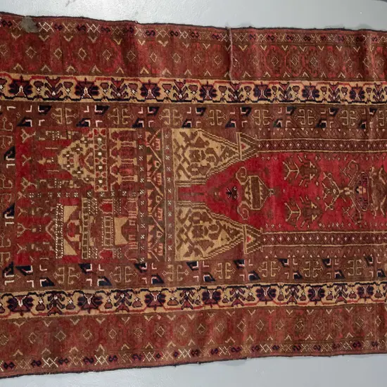small Persian style hand knotted wool floor rug - reds and browns - areas of wear L-1300 W-790
