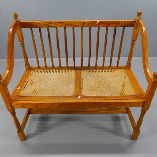 reproduction oak hall seat with bergere cane seat & spindle back H880 W950 D480