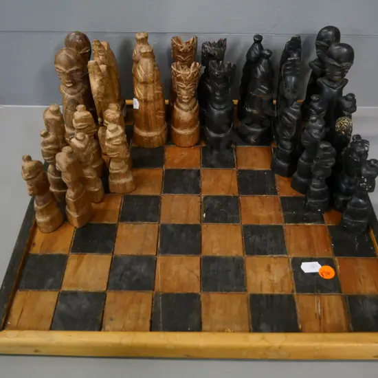 hand-carved wood chess set with board - tribal style figures, one pawn has damage - board 340x340