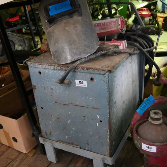 old mig welder with masks and rods
