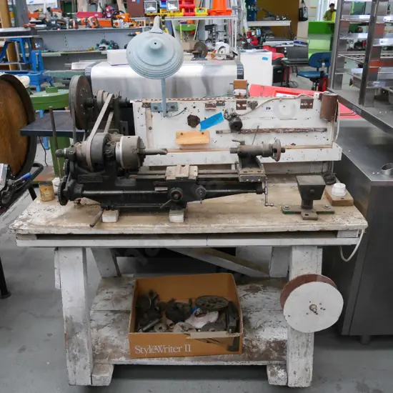 Companion metalworker's lathe on homemade illuminated stand and box of lathe accessories