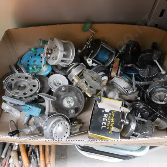 box of various fishing reels and parts