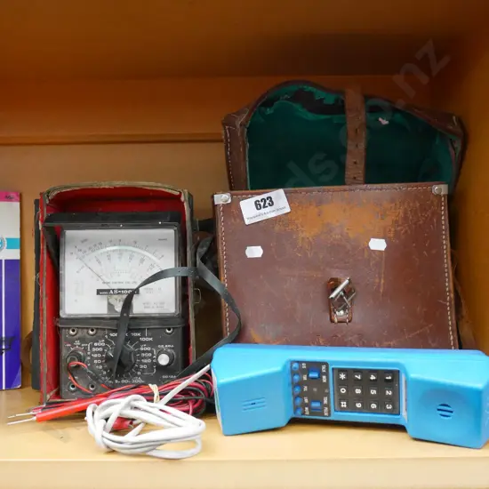 amp meter, linesman phone, leather satchel