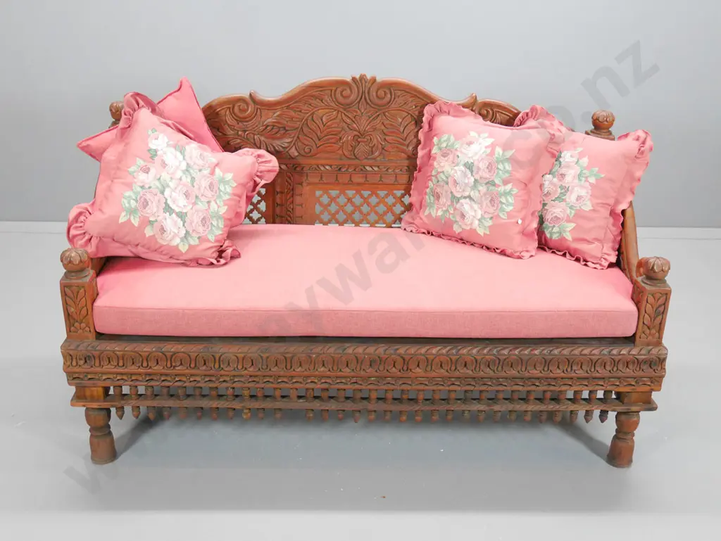 ornately carved teak settee with seat squab and loose cushions H-900 W-1470 D-640 Image 1++