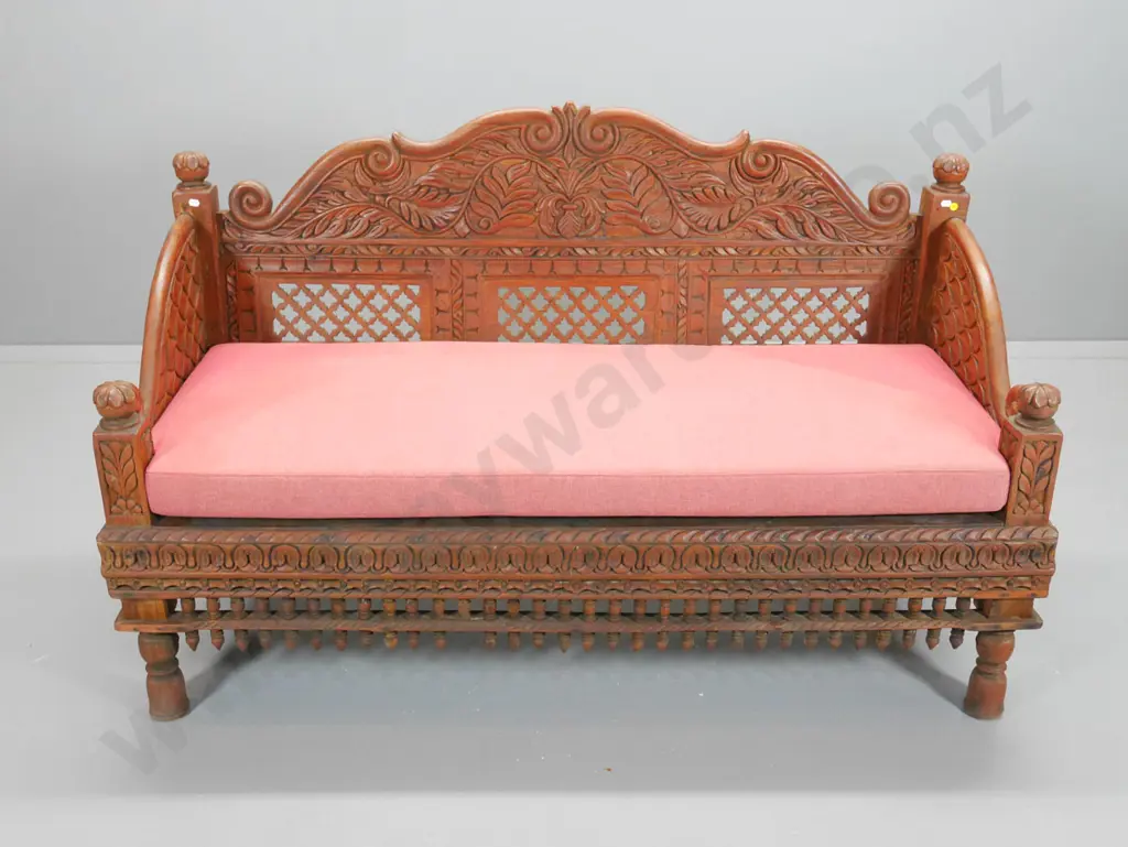 ornately carved teak settee with seat squab and loose cushions H-900 W-1470 D-640 Image 1++