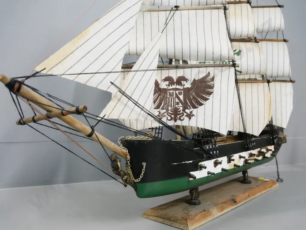 wooden model sailing ship on stand - unknown insignia on sails. H570 L750 Image 1++