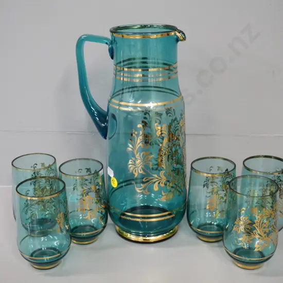 retro turquoise glass with gilt pattern 7-piece water set in as-new condition. Jug H-300