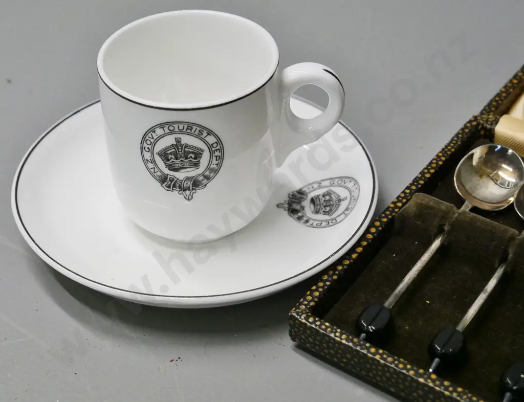 cased set of plated coffee bean spoons and 2 Tuscan demi-tasse cups & saucers with NZ Gov. Tourist Dept. logos Image 1++