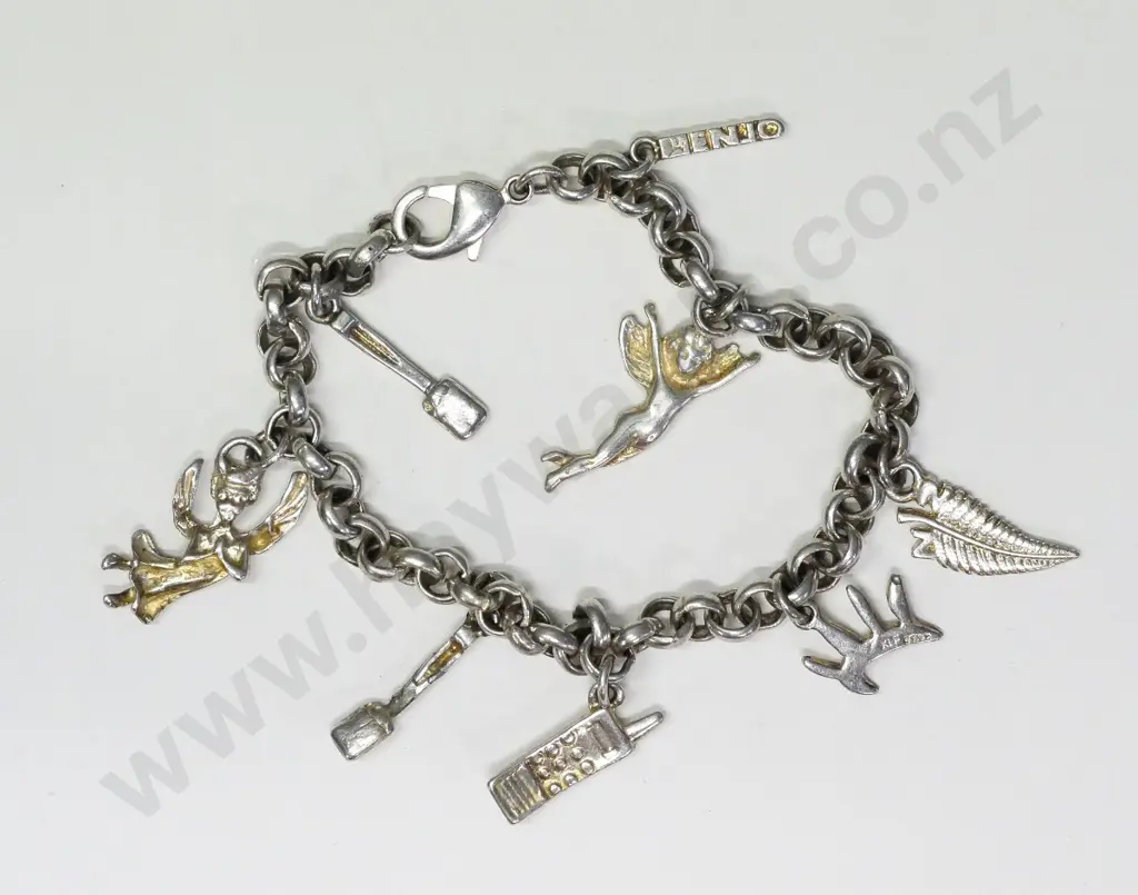 silver charm bracelet with 8 charms some charms are stamped stg or 925 Image 1++
