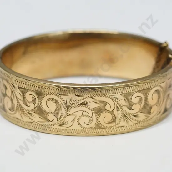gold bangle one half engraved with safety chain stamped 9ct