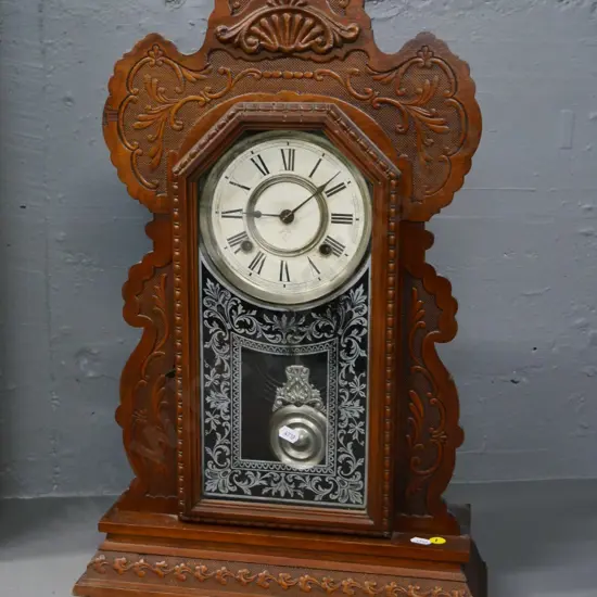 Ansonia mantel clock in carved wooden case, with key, some borer H-570 W-370 D-130