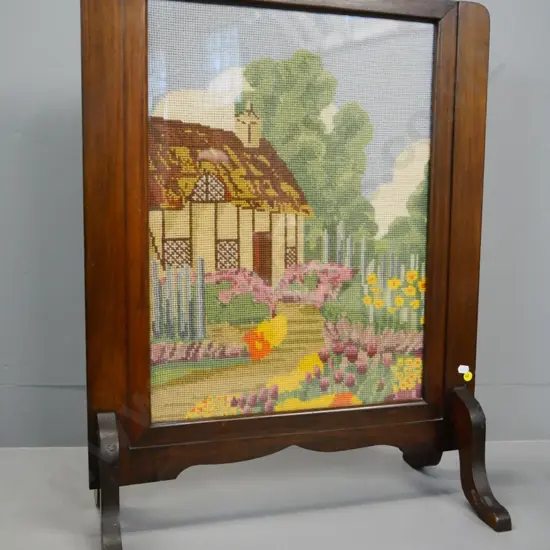 retro beech-framed fire guard with glazed cottage scene tapestry panel, repairs to 1 foot H690 W550