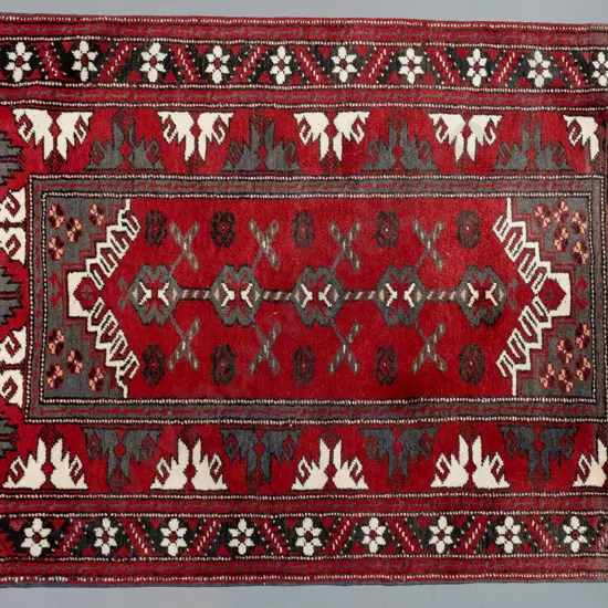 hand-knotted wool Persian style floor rug - red, black and cream - one end faded L-1600 W-1150