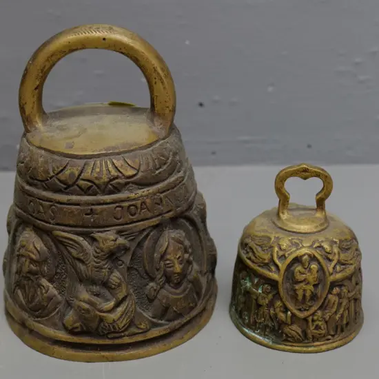 2 ornate heavy cast brass bells with medieval motifs - larger is H-150 D-150