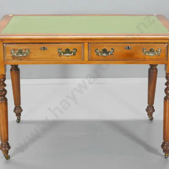 vintage kauri small writing desk w/tooled leather inset, 2 drawers with brass handles, on metal casters H760 W1060 D680