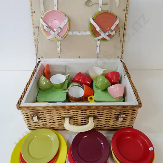 plastic cane picnic basket fitted with Falcon Duraware and other colourful cups, saucers, etc.