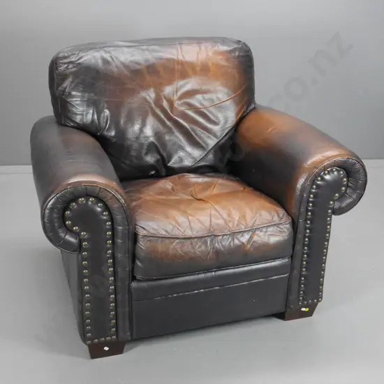 club style antiqued finish leather armchair w/ large stud facings, rubbing to sides H950 W1060 D940