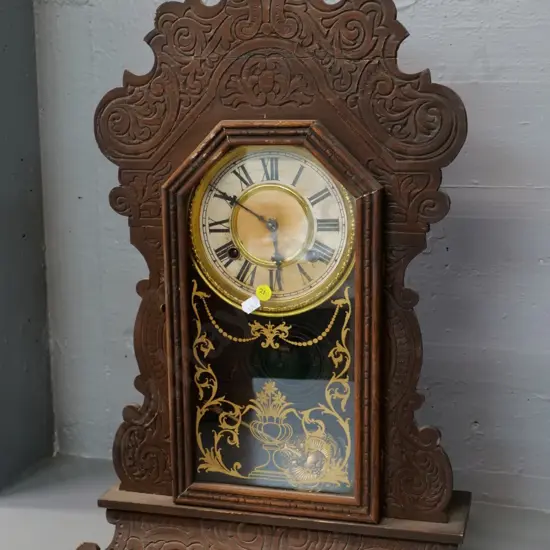 vintage Ansonia mantel clock w/press-carved panel (has had repair) brass face, with key, gilt  transfer on glass H560