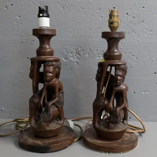 pair of carved hardwood table lamps with ethnic designs H-400, split to timber of one, other needs rewiring