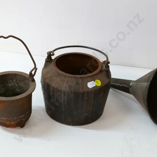 vintage cast iron glue pot H-240 with handle up, and a tin funnel