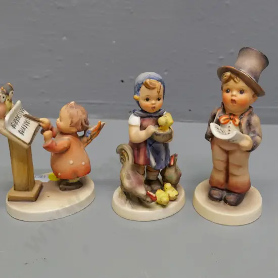 3 Goebels Hummel figurines - boy singer H-130, angel musician, girl with chickens