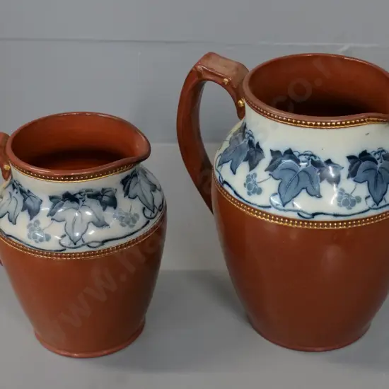 two English salt-glazed jugs with blue & white patterned band - taller is H-175