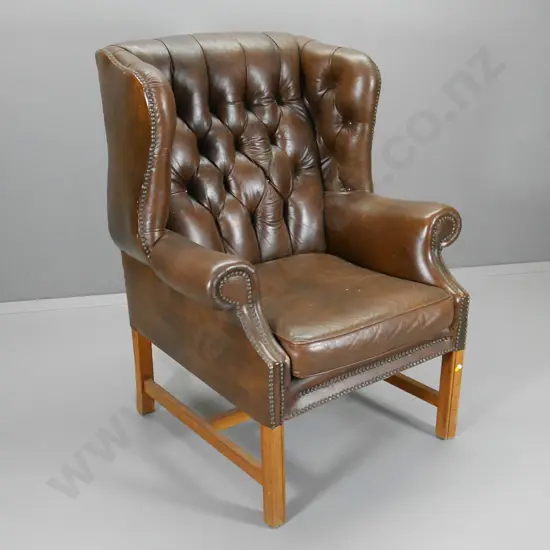 brown leather wing club chair with deep button back, studding, some rubbing to leather H1140 W880 D810