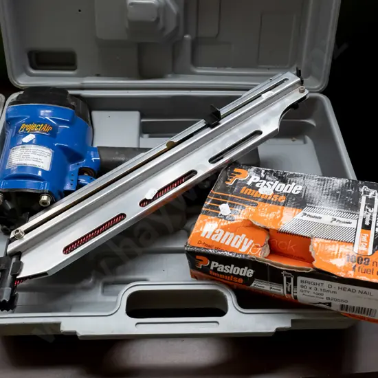 air powered nail gun and box of part nails