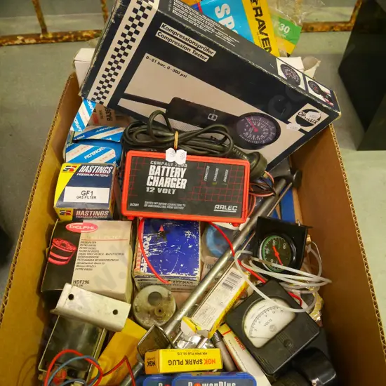 box of automobile allsorts; battery charger, dials etc