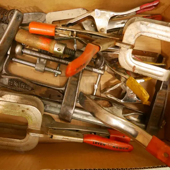 box of various welder's clamps