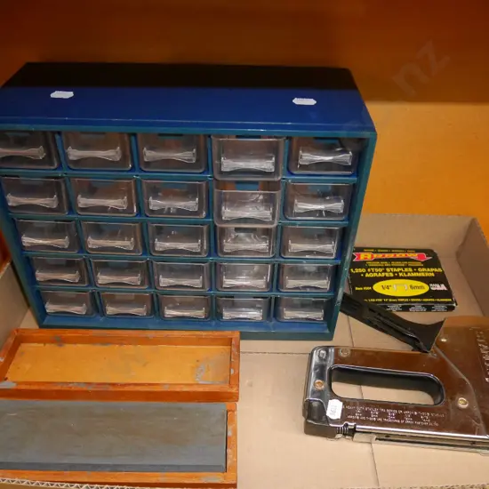small plastic storage trays, sharpening stone, staple gun