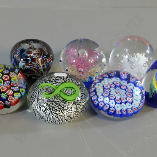 7 glass paperweights, 2 are millefiore style, one marked NZ