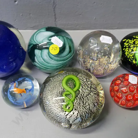 7 glass paperweights, one marked Vitrix '81, one marked NZ. Tallest is blue apple H-100