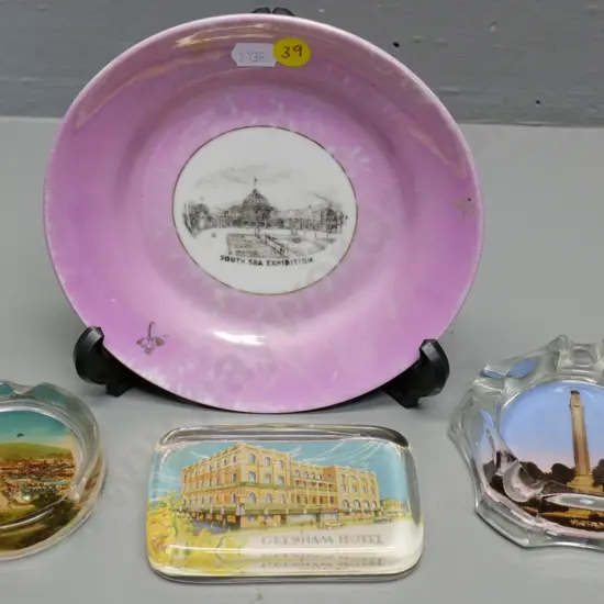 4 pieces souvenir ware - Dunedin Exhibition plate (worn) two Dunedin ashtrays, Brisbane paperweight D-170
